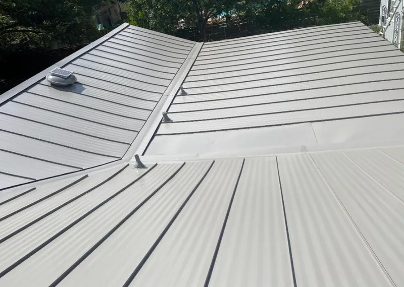 Solar attic fan installed on a metal roof for Roof Ventilation in Rainsville